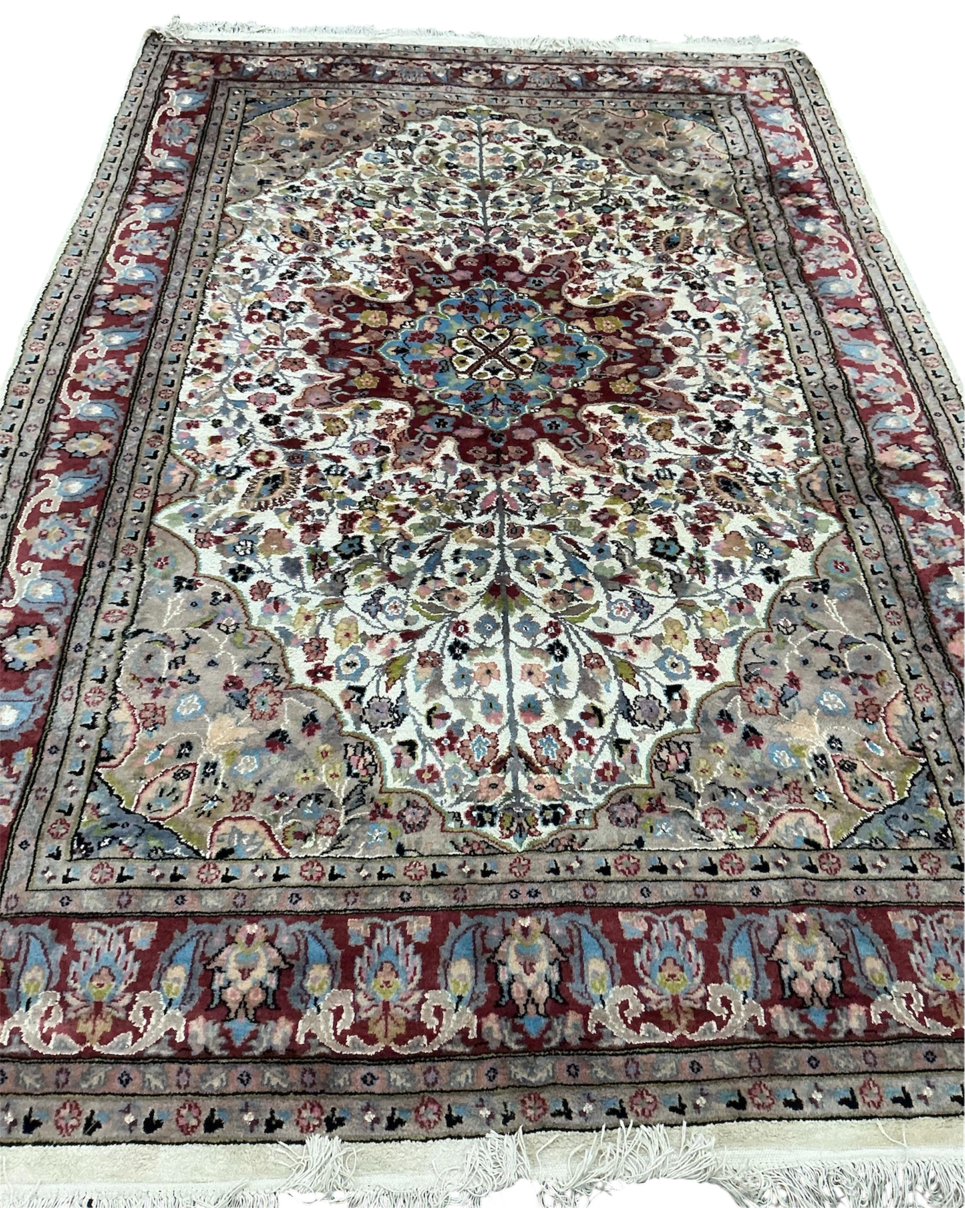 A Pakistan ivory ground part silk medallion carpet, 283 x 192cm